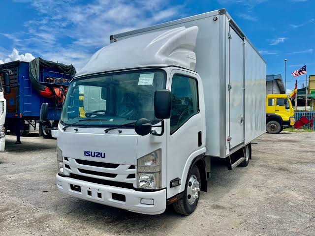 Isuzu NPR85 box van truck for enclosed commercial deliveries.

