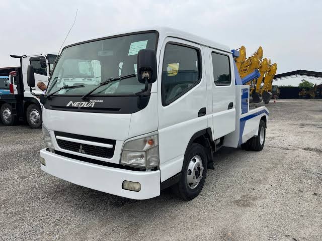 Mitsubishi Fuso FE83 double-cab towing truck.
